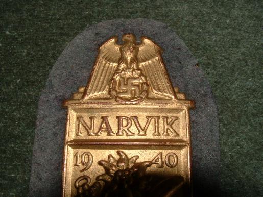 NEAR MINT NARVIK SHEILD IN GILT WITH FULL BACKING.