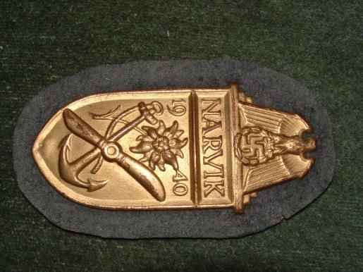 NEAR MINT NARVIK SHEILD IN GILT WITH FULL BACKING.